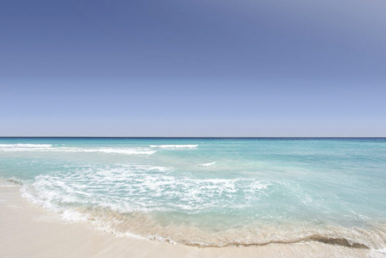 beach with white sand and clear water