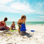 family beach ocean sandcastles